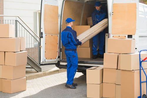 Removal van and moving team preparing a home move in Tolworth