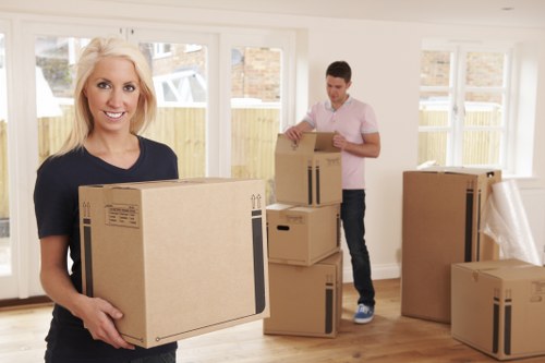 Moving boxes and furniture being carried from a Tolworth home