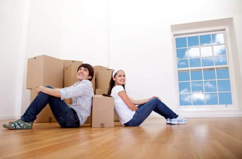 Local moving helper carrying boxes near Tolworth homes