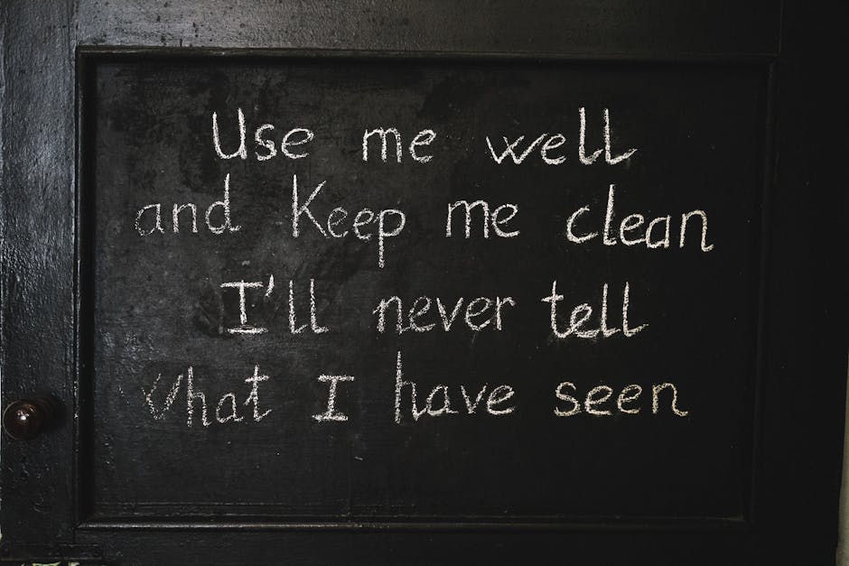 A black chalkboard with a wooden frame, featuring handwritten white chalk text that reads: 'Use me well and keep me clean I'll never tell what I have seen.' The board is positioned against a wall, possibly in a home or an office setting, with the text appearing prominently in the center. The handwriting is casual and slightly uneven, adding a personal touch. The surrounding environment hints at an interior space, with no other furniture or objects visible in the image. This scene may relate indirectly to household or office environments where furniture or decorative boards are used, aligning with themes of moving or relocation services by Man with Van Tolworth, although the image itself focuses on the message on the chalkboard.